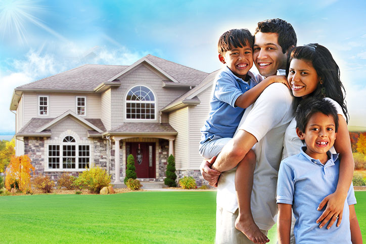 Family standing in front of house