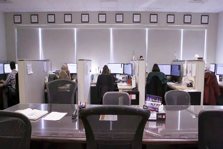 Wide angled photo of poison specialists working in the operations area of the Maryland Poison Center