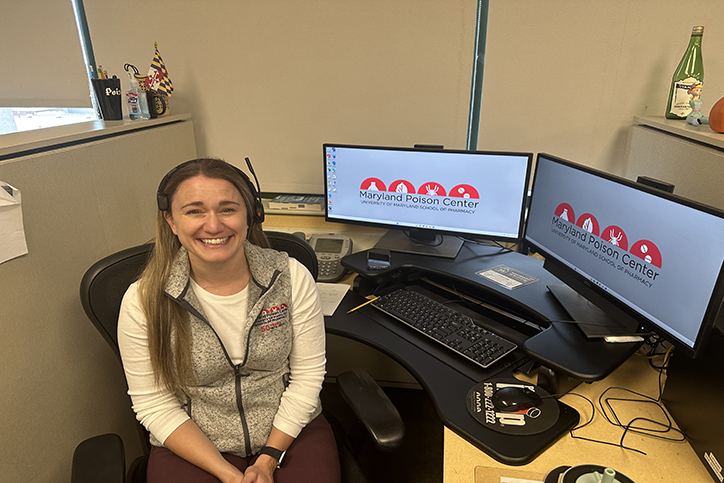 Sara Morgan sitting at desk with phone headset on