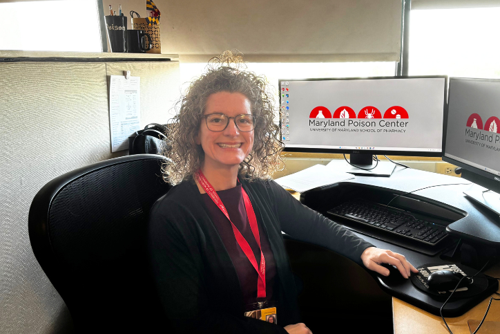 A Maryland Poison Center poison specialist sitting at her desk.